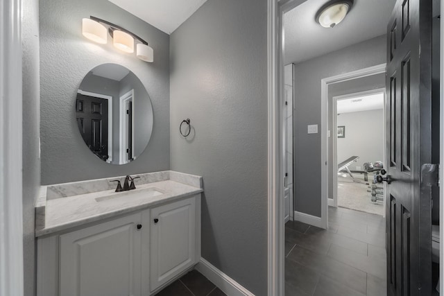 bathroom featuring toilet, tile patterned floors, and vanity