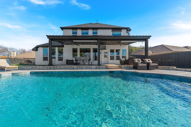 view of swimming pool featuring a patio area, ceiling fan, and outdoor lounge area