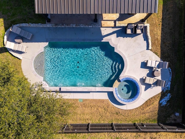 view of pool with an in ground hot tub