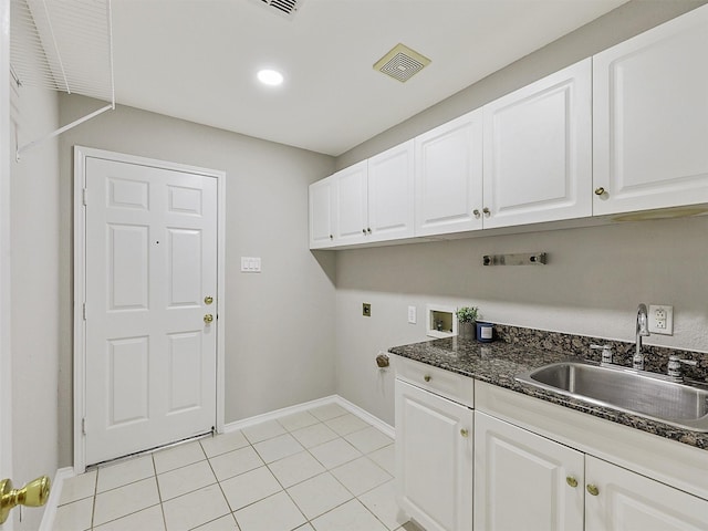 washroom featuring sink, cabinets, washer hookup, hookup for an electric dryer, and light tile patterned floors