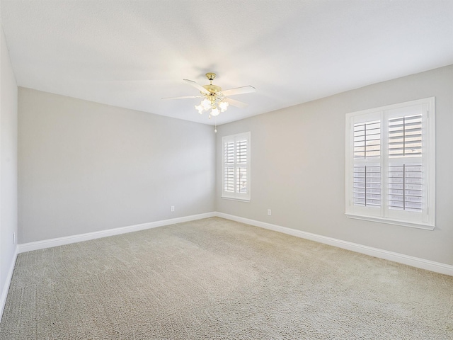 carpeted spare room with ceiling fan and a healthy amount of sunlight