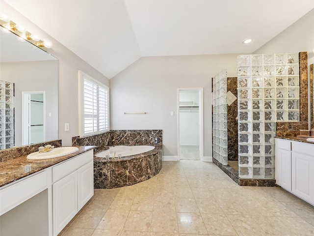 bathroom featuring plus walk in shower, vanity, tile patterned floors, and lofted ceiling