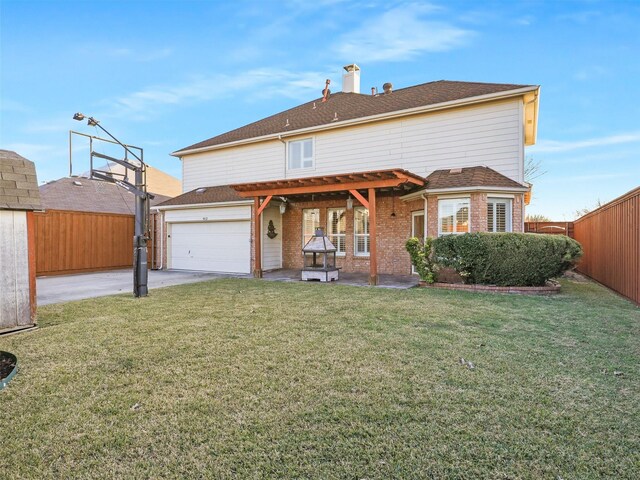 rear view of house with a yard, a patio, and a garage