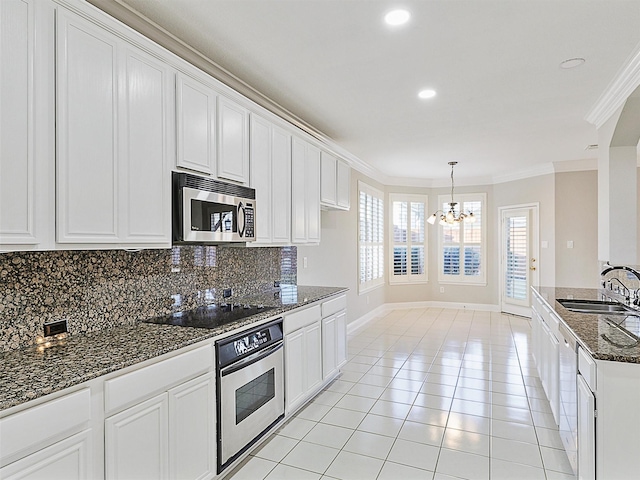 kitchen with dark stone countertops, sink, white cabinetry, and stainless steel appliances