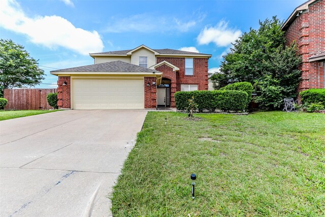 front facade featuring a front lawn and a garage