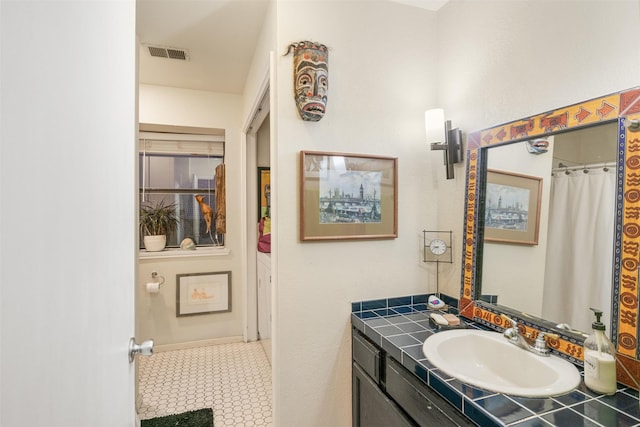 bathroom featuring tile patterned flooring and vanity