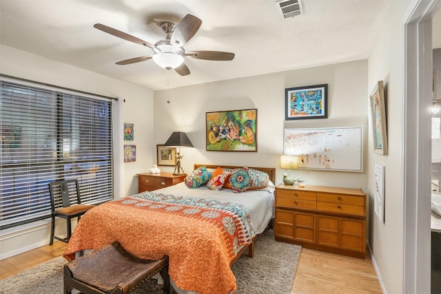 bedroom with light hardwood / wood-style floors and ceiling fan