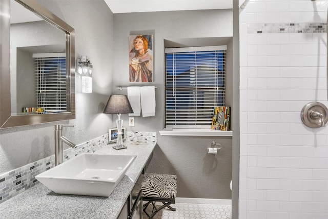 bathroom featuring a shower and sink