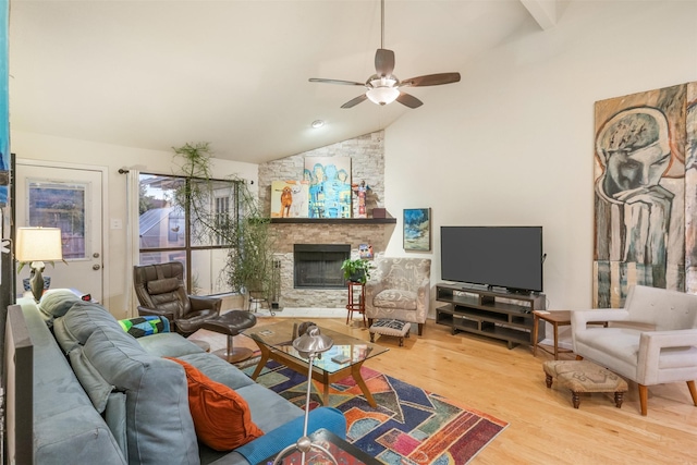 living room with hardwood / wood-style floors, vaulted ceiling with beams, ceiling fan, and a fireplace