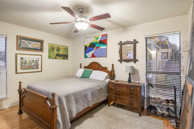 bedroom with light hardwood / wood-style flooring and ceiling fan