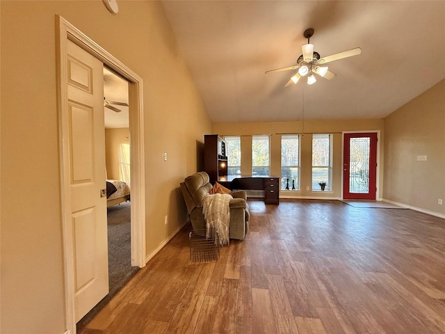 living room featuring ceiling fan, lofted ceiling, and hardwood / wood-style flooring