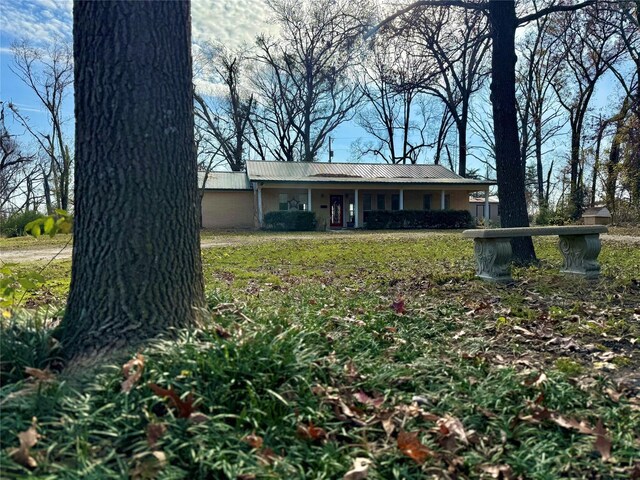 property entrance featuring a porch and brick siding