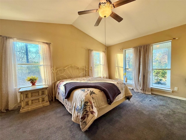 bedroom with ceiling fan, vaulted ceiling, and dark colored carpet