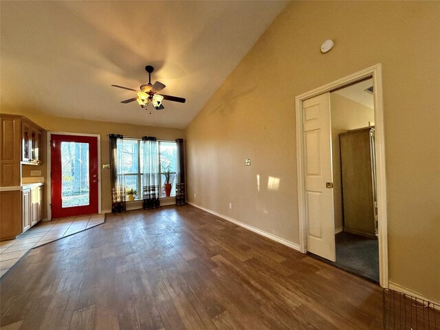 kitchen with black electric range, light tile patterned floors, open floor plan, and tile countertops