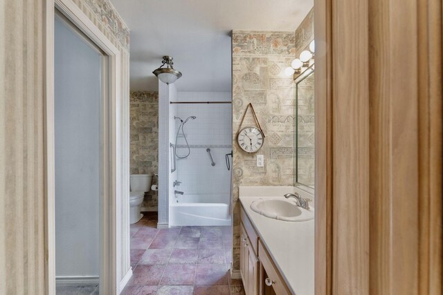 bathroom with connected bathroom, baseboards, vanity, and wallpapered walls