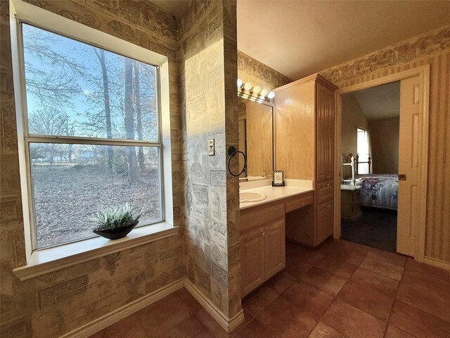 interior space featuring a sink, lofted ceiling, and tile patterned floors