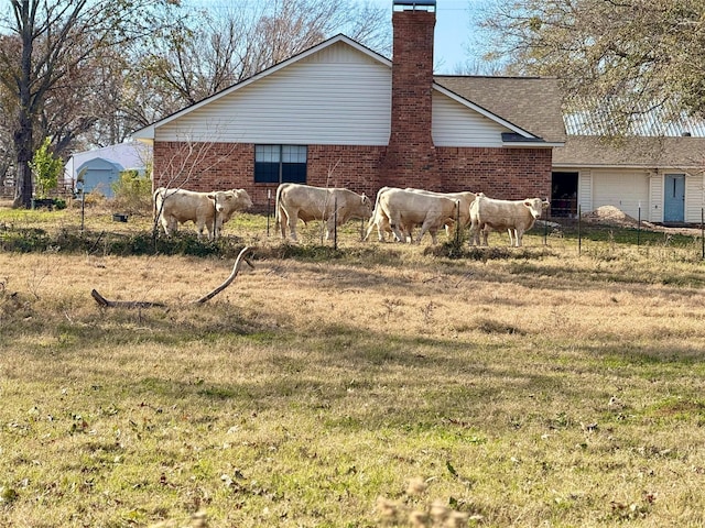 view of side of home with a yard