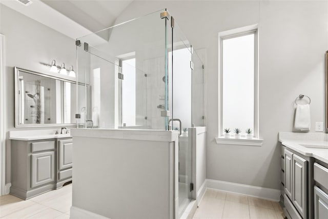 bathroom featuring vanity, tile patterned floors, walk in shower, and lofted ceiling