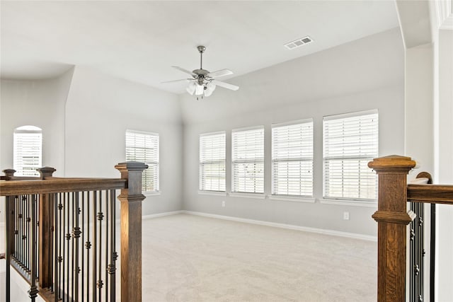 interior space with light colored carpet and lofted ceiling