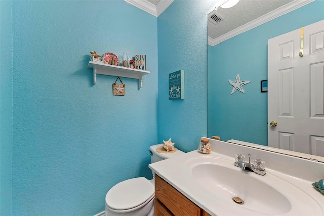 bathroom featuring crown molding, vanity, and toilet