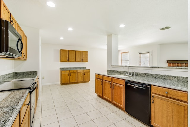 kitchen featuring light tile patterned floors, sink, light stone counters, and black appliances