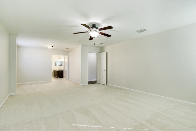 carpeted spare room with ceiling fan