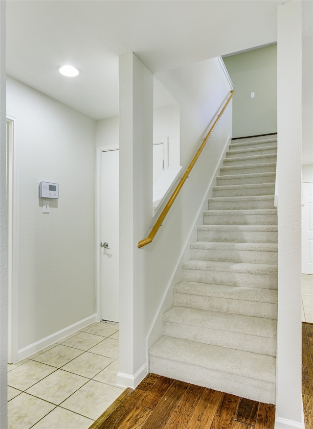 stairs with hardwood / wood-style flooring