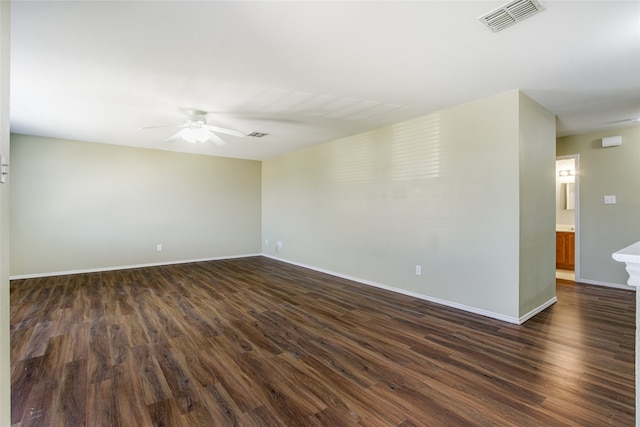 spare room featuring ceiling fan and dark hardwood / wood-style flooring