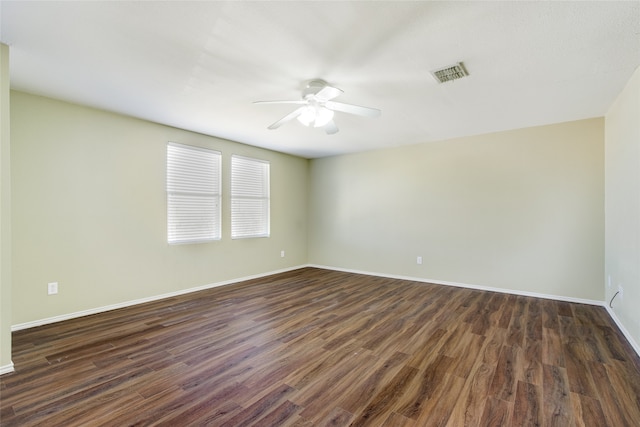 empty room featuring dark hardwood / wood-style floors and ceiling fan