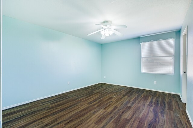 empty room featuring dark hardwood / wood-style flooring and ceiling fan