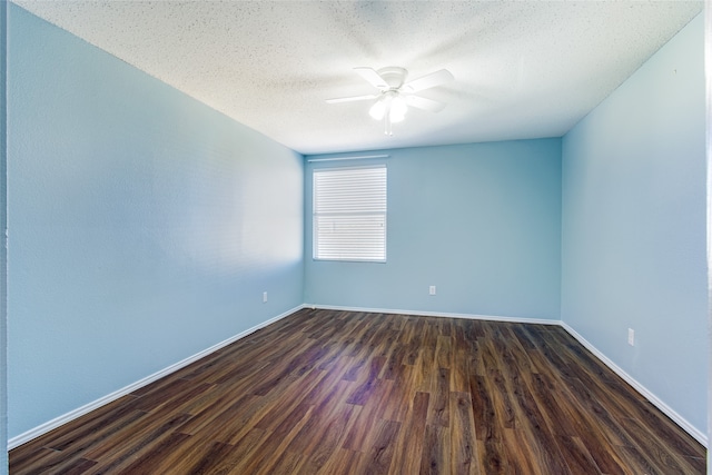 spare room featuring ceiling fan, dark wood-type flooring, and a textured ceiling