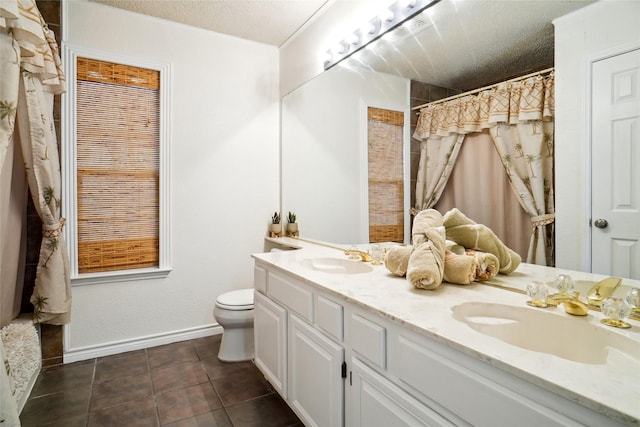 full bath with tile patterned flooring, a textured ceiling, and a sink