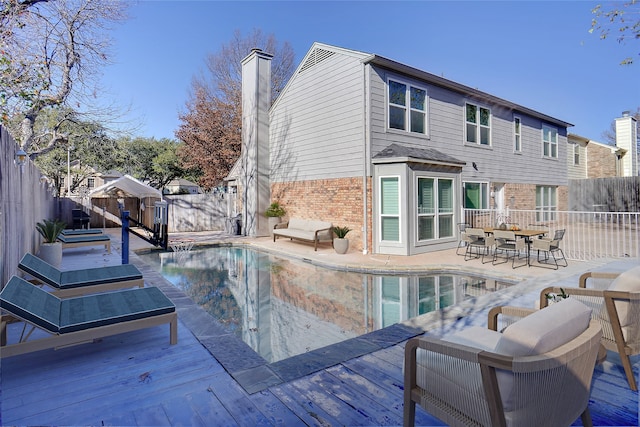 view of swimming pool with a fenced in pool, a wooden deck, and a fenced backyard