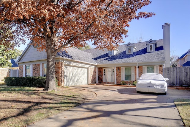 cape cod-style house featuring a garage