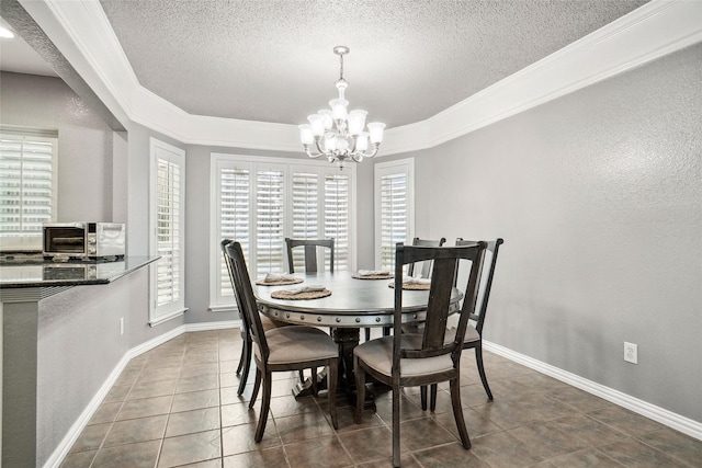 dining room featuring baseboards, a toaster, a notable chandelier, a textured ceiling, and dark tile patterned flooring