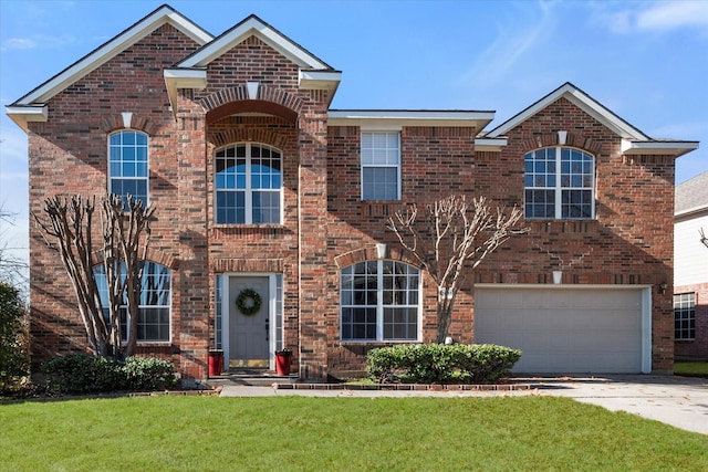 front facade featuring a garage and a front lawn