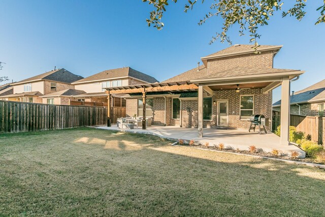 back of property with a lawn, a patio area, and ceiling fan