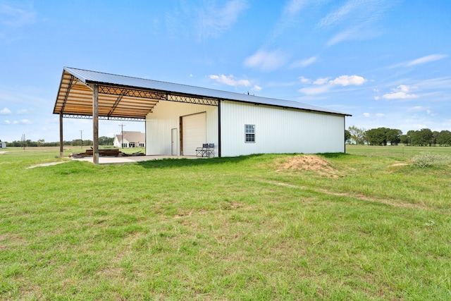 view of outdoor structure featuring a lawn and a garage