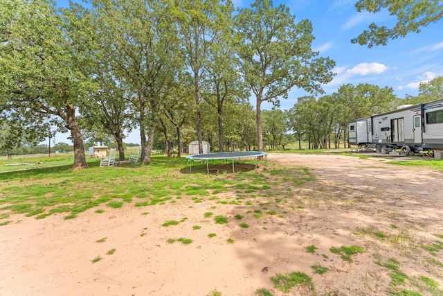 view of yard with a trampoline