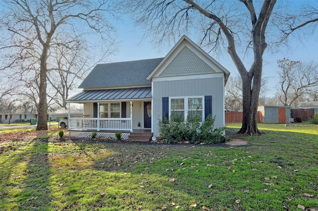 view of front of home with covered porch and a front yard