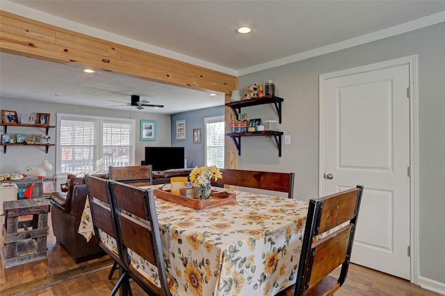 dining space with ceiling fan and dark wood-type flooring