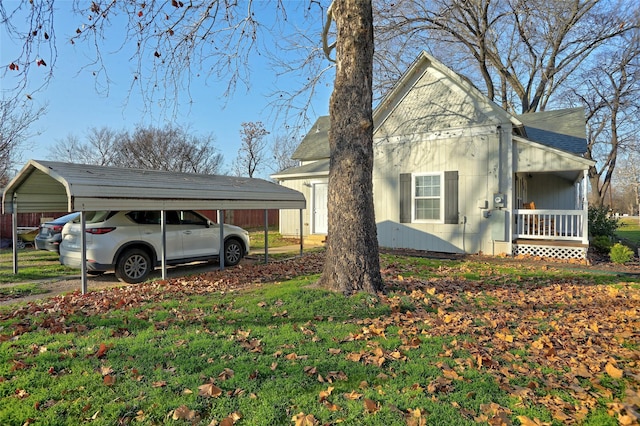 view of home's exterior featuring covered porch and a carport