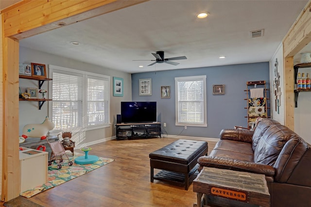 living room featuring ceiling fan and light wood-type flooring