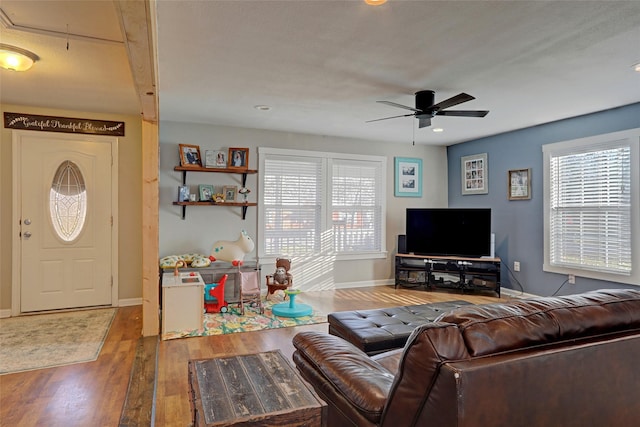 living room with hardwood / wood-style flooring and ceiling fan