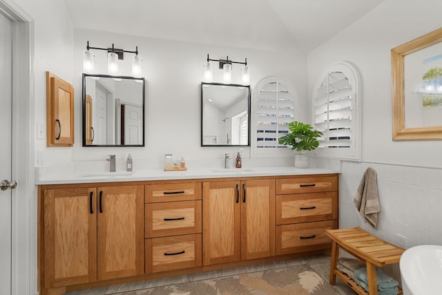 bathroom with vanity and lofted ceiling