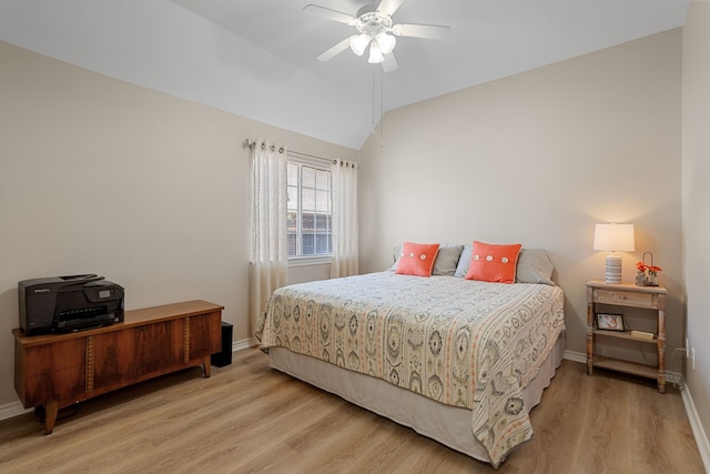 bedroom featuring ceiling fan, light wood-type flooring, and lofted ceiling