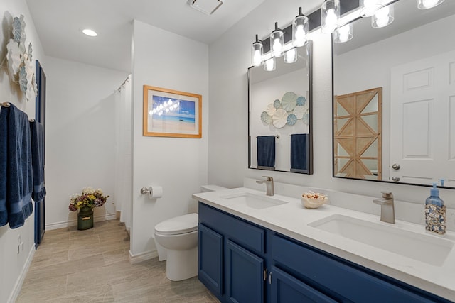 bathroom featuring vanity, toilet, and walk in shower