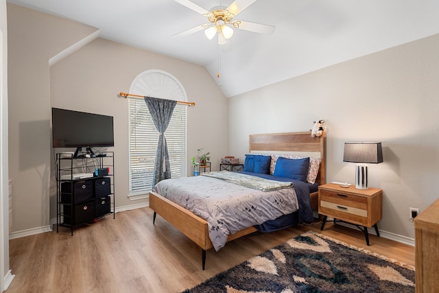 bedroom with ceiling fan, wood-type flooring, and lofted ceiling