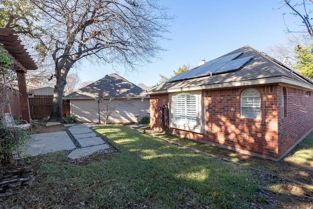 exterior space featuring solar panels, a yard, and a patio area