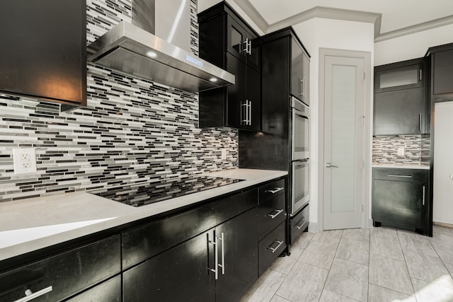 kitchen featuring black electric stovetop, light tile patterned floors, double oven, wall chimney range hood, and tasteful backsplash